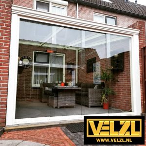 Crème-witte veranda met een glazen schuifwand